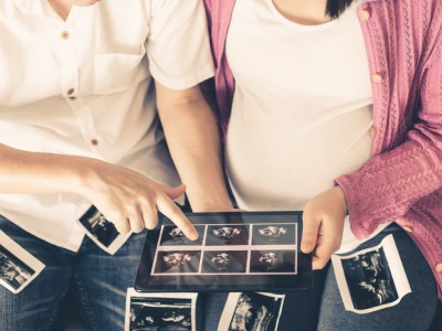 Prospective parents review ultrasound images of baby.